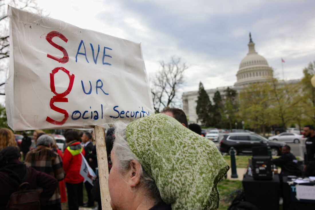 A person holds a sign reading "Save Our Social Security" during a rally in support of fair taxation near the U.S. Capitol on April 10, 2025.