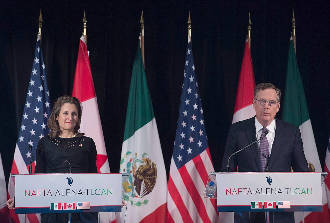 A man and a woman stand at podiums.