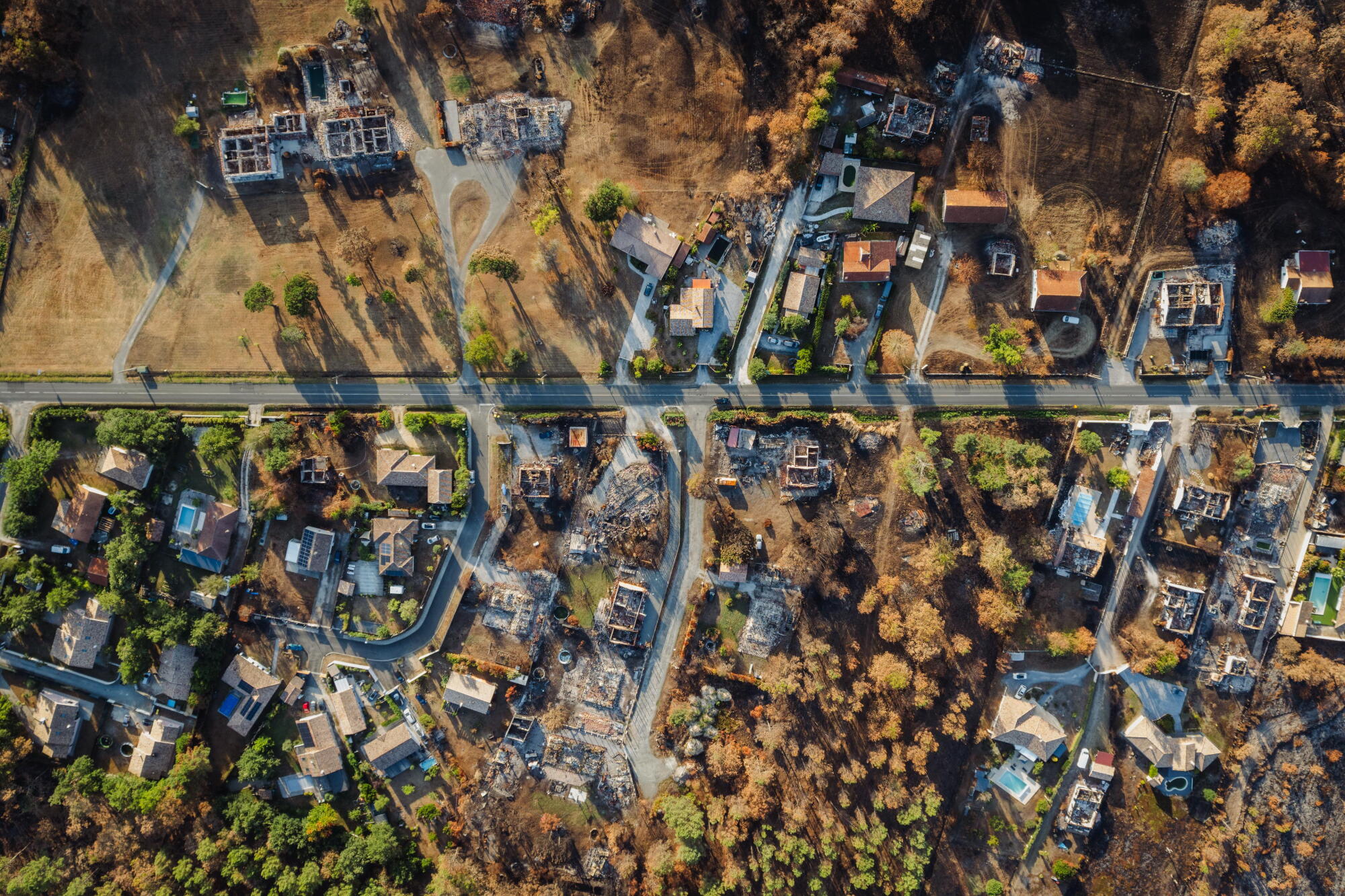 An aerial view of a suburban neighborhood that suffered a fire.