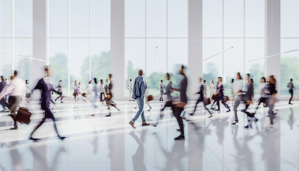 Businessman walking in crowds of people