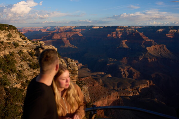 People stand at the rim of the Grand Canyon, Monday, Aug. 31, 2026, in Grand Canyon National Park, Ariz. (AP Photo/John Locher)