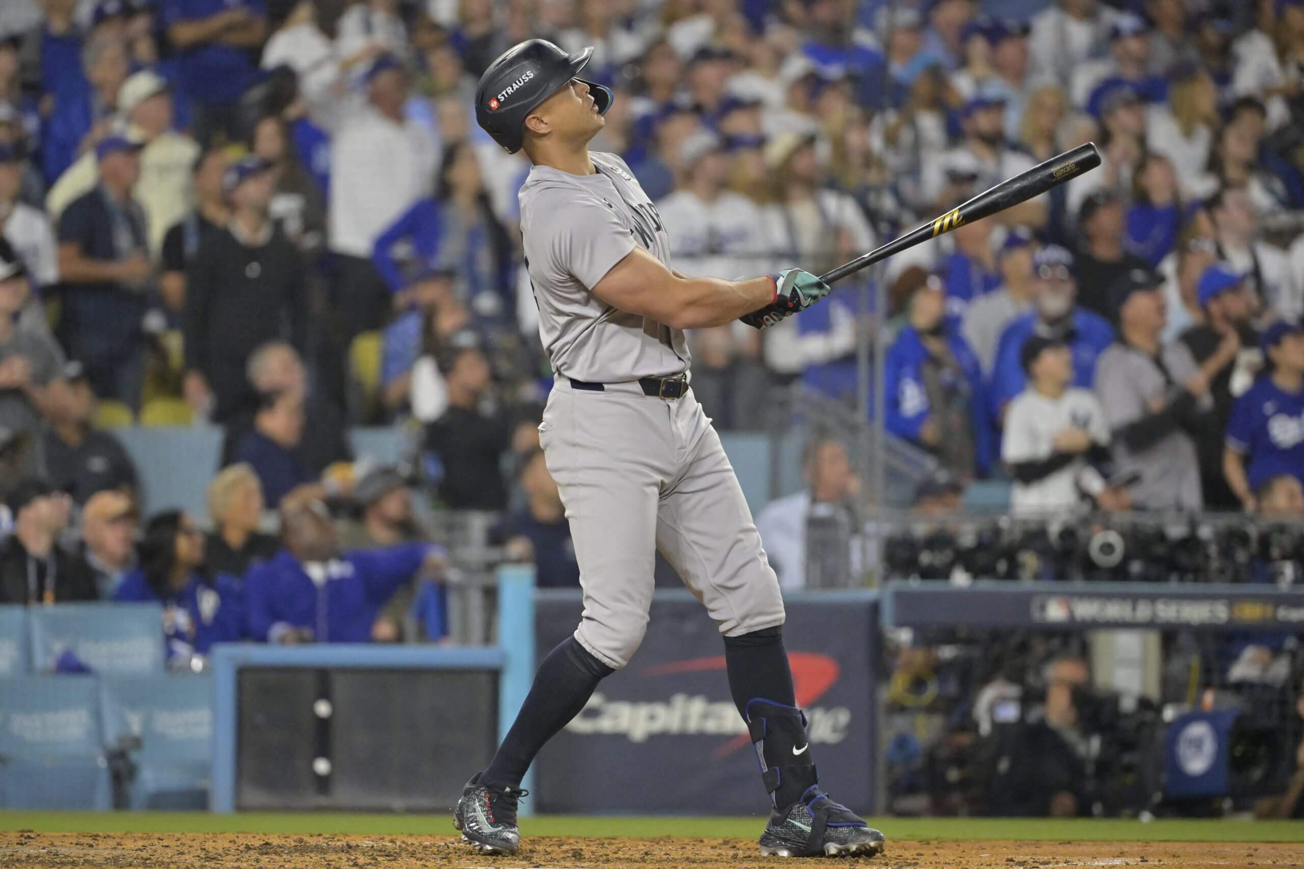 Giancarlo Stanton follows through on his swing and watches his ball after hitting a home run in Game 1 of the 2024 World Series.