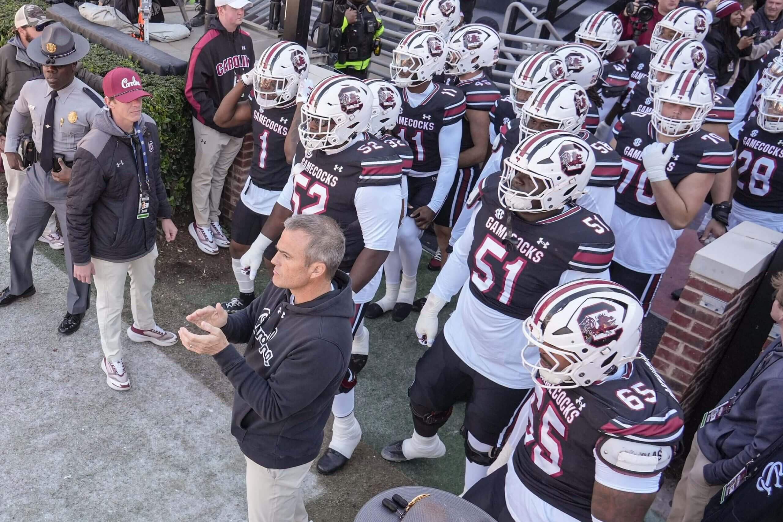 Shane Beamer claps his hands while standing in front of South Carolina players before entering the field