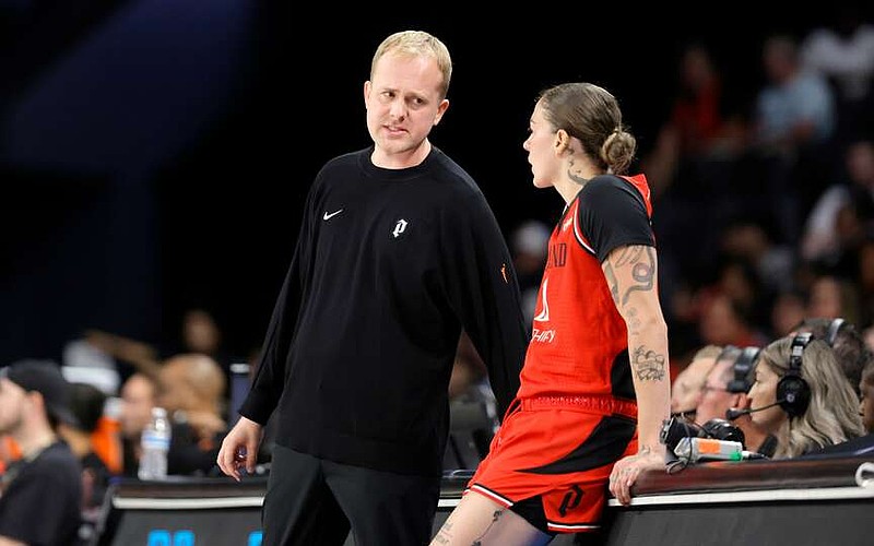 Portland Fire head coach Alex Sarama talks with forward Emily Engstler (21) during the first half of an WNBA basketball game against the Las Vegas Aces Tuesday, July 28, 2026, in Las Vegas. (Steve Marcus/Las Vegas Sun via AP)