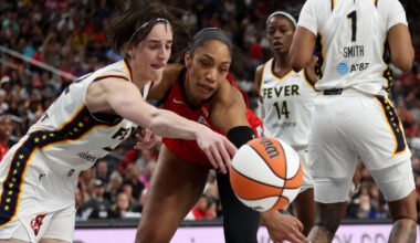 Indiana Fever guard Caitlin Clark, left, and Las Vegas Aces center A'ja Wilson, center, vie for ...