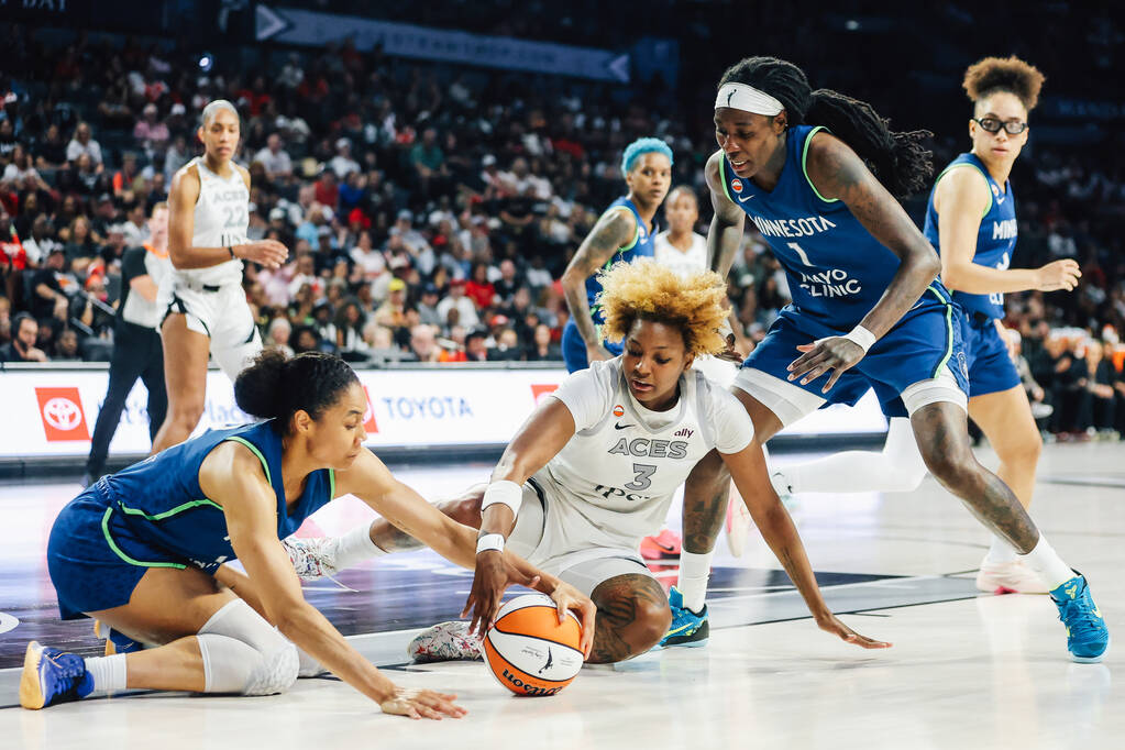 Aces forward NaLyssa Smith (3) fights against Minnesota Lynx forward Nia Coffey (12) for a loos ...