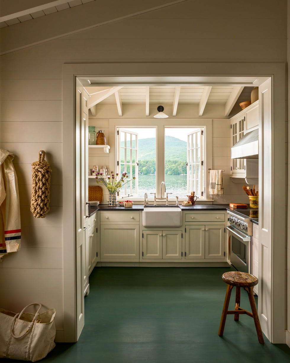 Bright, airy kitchen with open windows overlooking a serene lake Bright, airy kitchen with open windows overlooking a serene lake