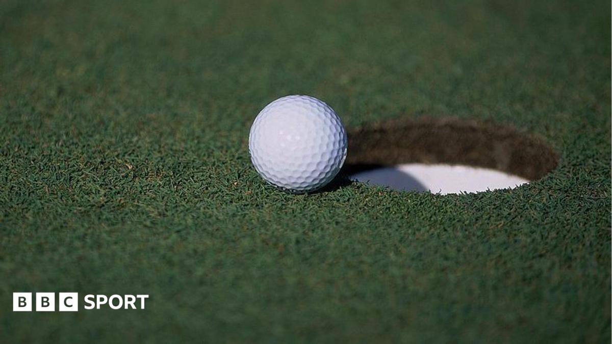 A general view of a golf ball sitting near a hole