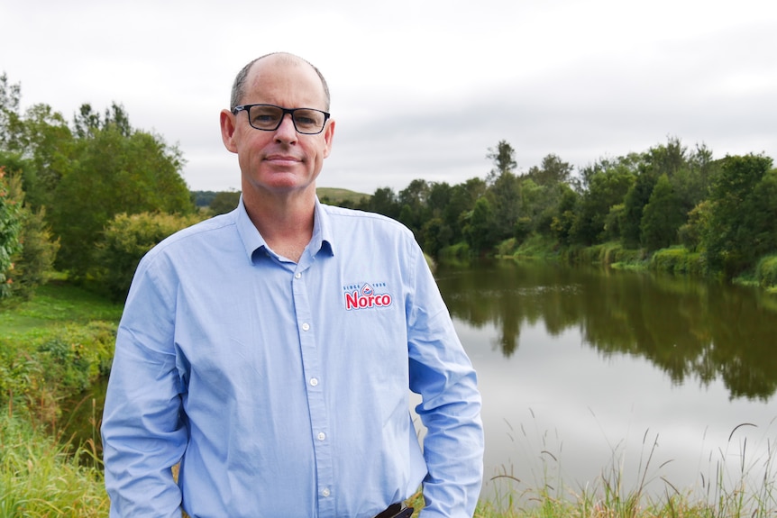 Michael Hampson standing in front of a lake. 