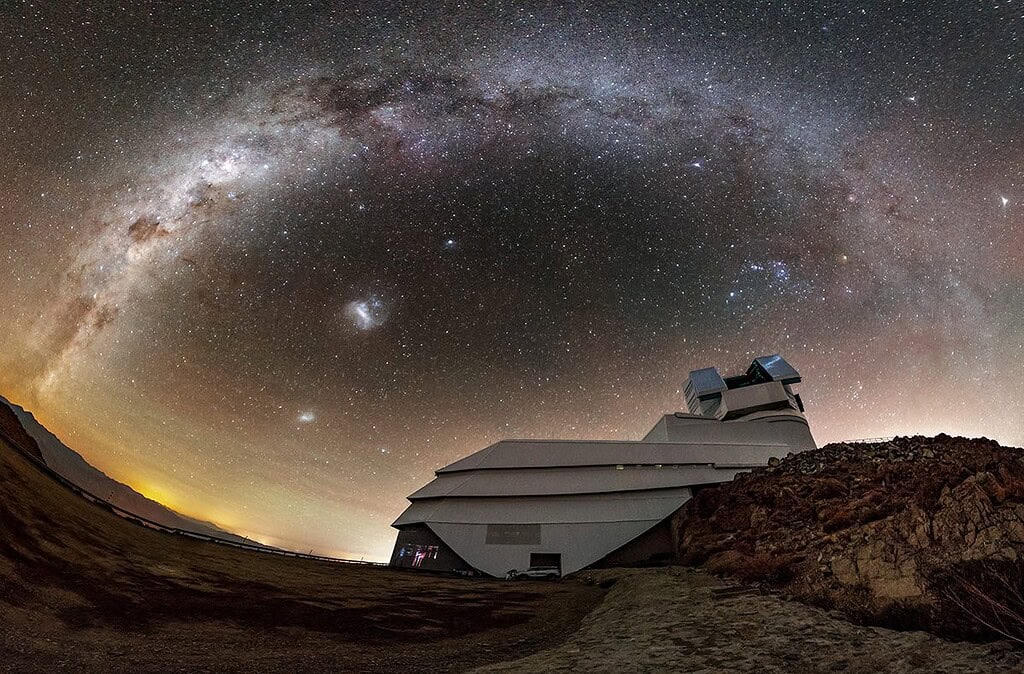 Wide angle photo of the Vera C. Rubin Observatory agaisnt a starry sky in the background
