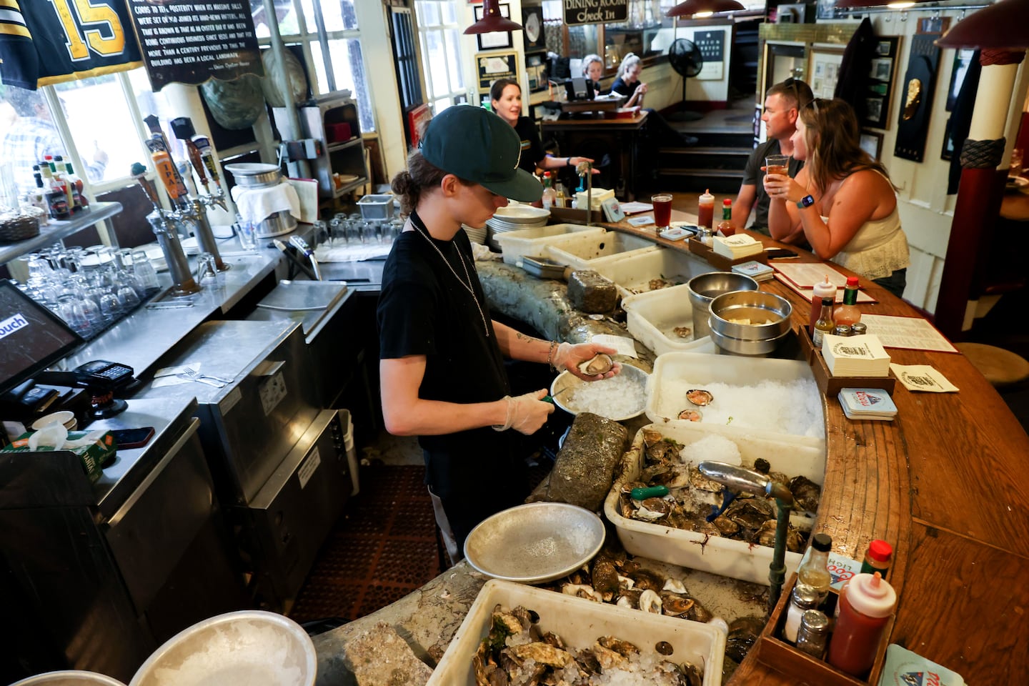 Thomas Butler, 21, working at the historic Union Oyster House in Boston in July 2025.