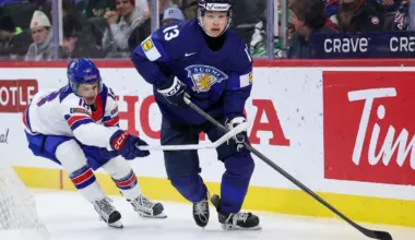 Finland defenseman Veeti Vaisanen (13) skates with the puck as United States forward L.J. Mooney (18) defends during the third period in the quarterfinals of the 2026 IIHF World Junior Championship at Grand Casino Arena.