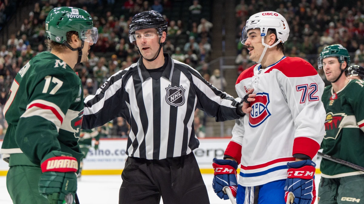 linesman Kyle Flemington (55) breaks up Minnesota Wild left wing Marcus Foligno (17) and Montreal Canadiens defenseman Arber Xhekaj (72) during an altercation in the third period at Xcel Energy Center.