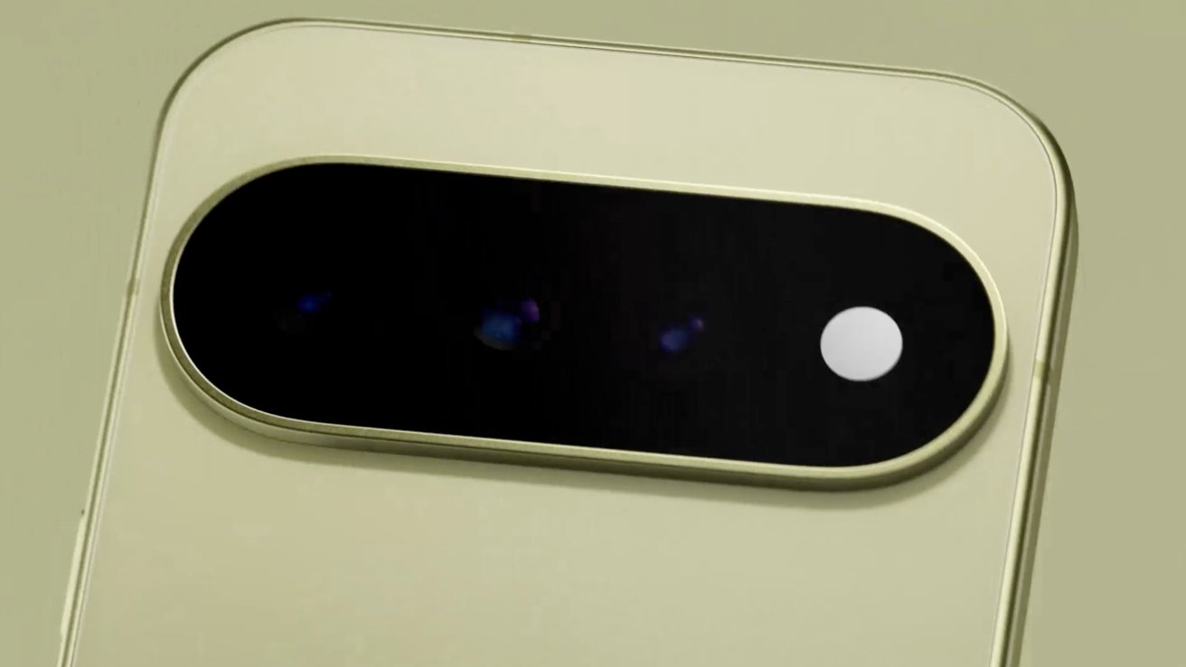 Close-up of a beige smartphone's rear camera module with a horizontal black oval housing multiple lenses and a small white flash on a smooth, light-colored back panel