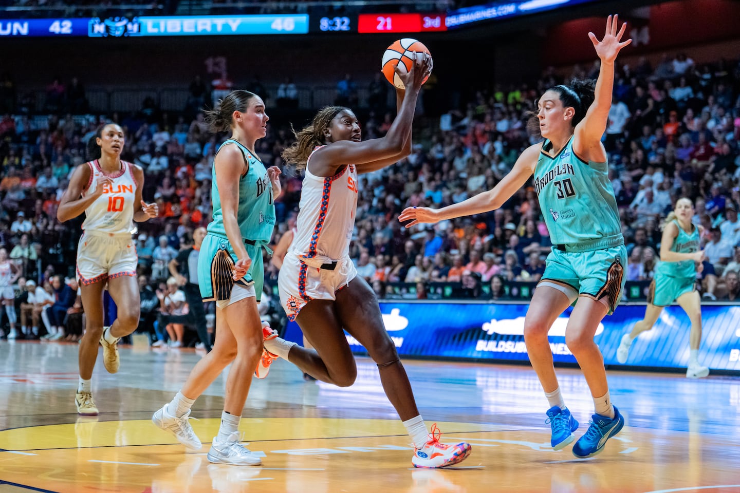 Diamond Miller, No. 1 of the Connecticut Sun, drives to the rim.