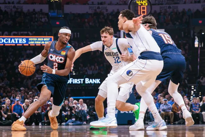 OKLAHOMA CITY, OKLAHOMA - DECEMBER 05: Shai Gilgeous-Alexander #2 of the Oklahoma City Thunder drives to the basket around Cooper Flagg #32 of the Dallas Mavericks during the first half at Paycom Center on December 5, 2025 in Oklahoma City, Oklahoma. NOTE TO USER: User expressly acknowledges and agrees that, by downloading and or using this photograph, User is consenting to the terms and conditions of the Getty Images License Agreement. (Photo by William Purnell/Getty Images)