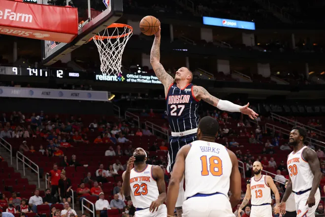 Dec 16, 2021; Houston, Texas, USA; Houston Rockets center Daniel Theis (27) dunks against New York Knicks center Mitchell Robinson (23) and guard Alec Burks (18) in the first quarter at Toyota Center. Mandatory Credit: Thomas Shea-USA TODAY Sports