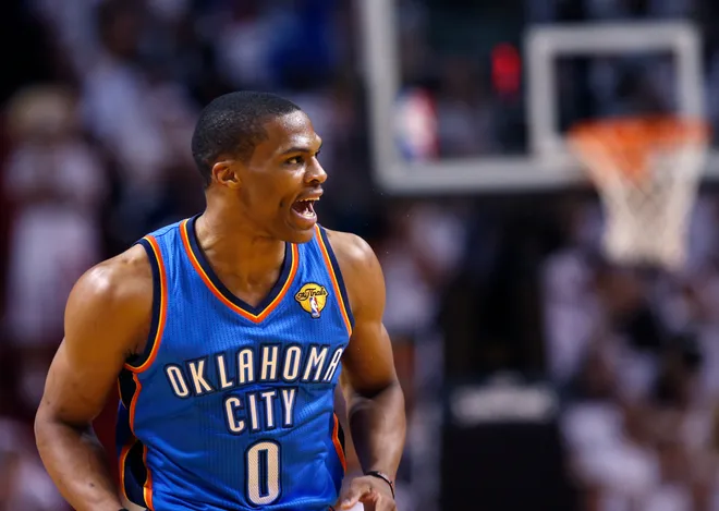 Oklahoma City Thunder guard Russell Westbrook reacts after making a basket in the first half against the Miami Heat during Game 4 of the NBA basketball finals in Miami, Florida, June 19, 2012. REUTERS/Mike Segar (UNITED STATES  - Tags: SPORT BASKETBALL)