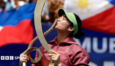 Alexandra Eala kisses the trophy