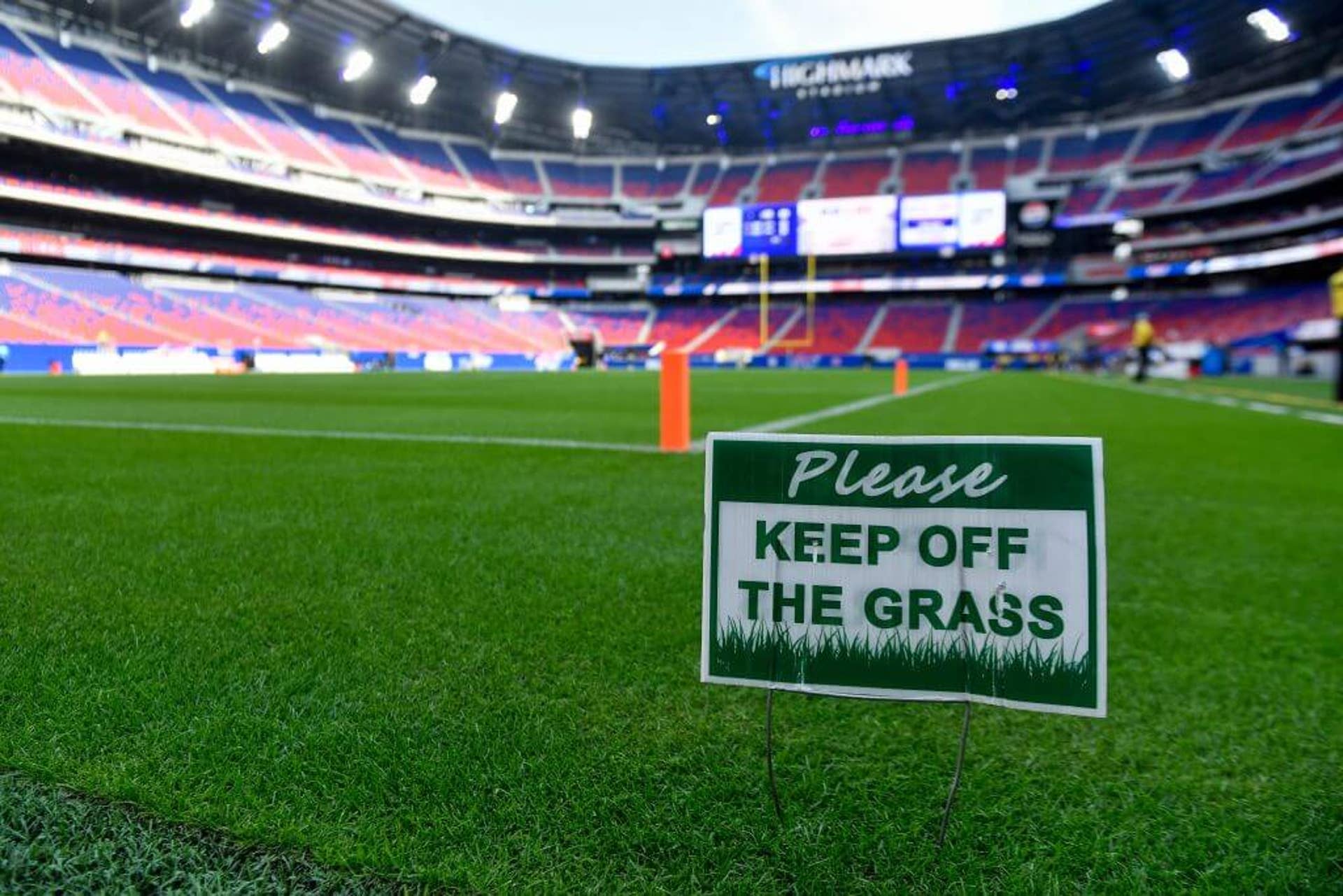 A "Keep off the Grass" sign stands on the field of Highmark Stadium before a Buffalo Bills practice at the team's NFL football training camp.