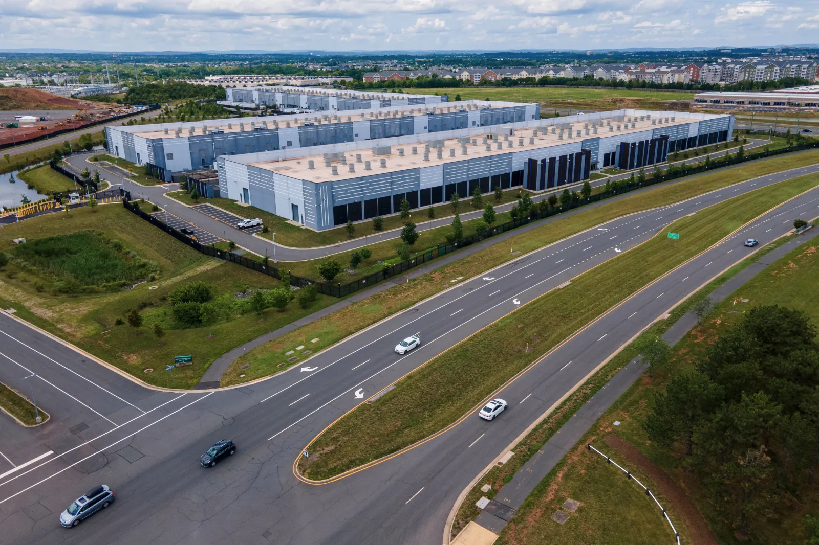 Cars drive past data centers on July 16, 2023, in Ashburn, Virginia. (AP Photo/Ted Shaffrey, File)