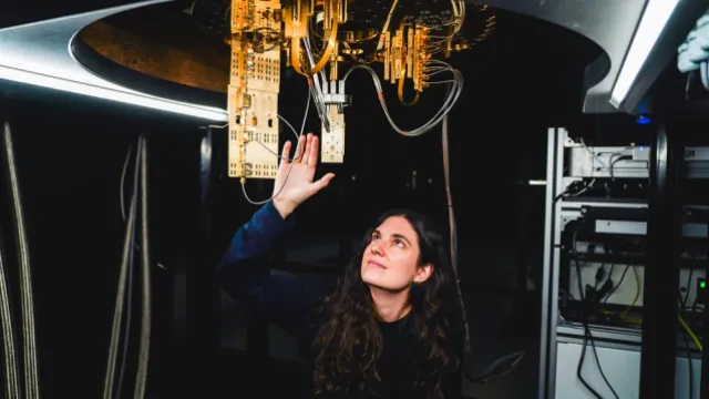 Barcelona Supercomputing Center’s Alba Cervera-Lierta standing under the first quantum computer in Spain developed with 100% European technology.
