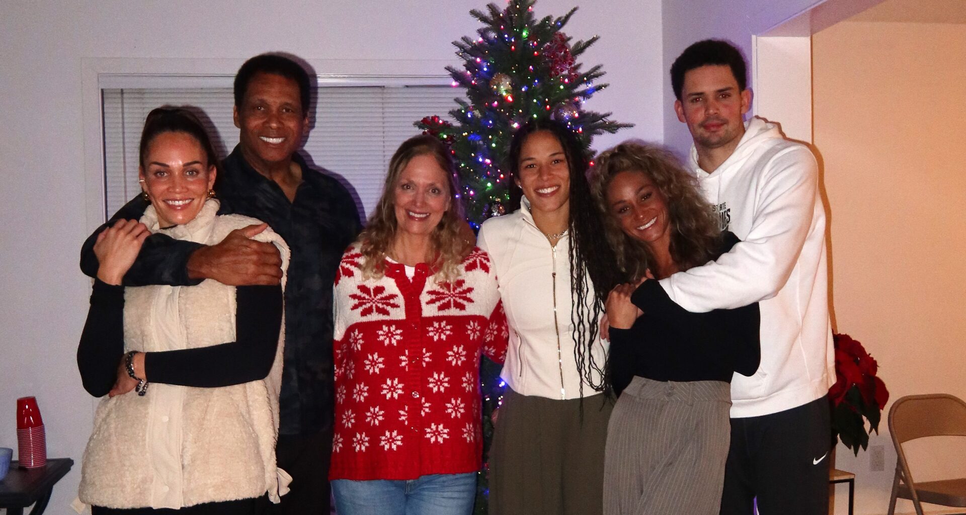 Golden State Valkyries guard Veronica Burton (third from right) poses for a holiday photo with her parents, two sisters and brother.
