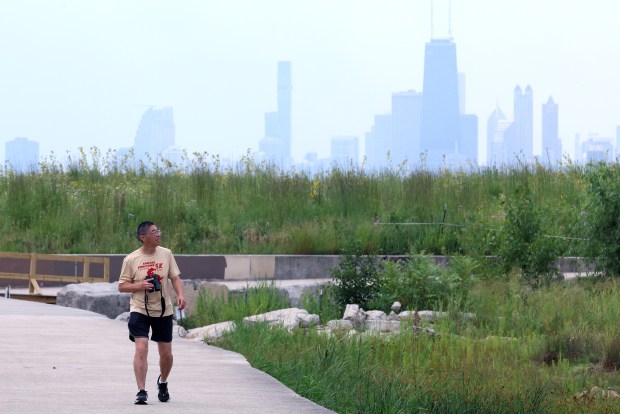 New birder Edward Shih keeps an eye out for birds at Montrose Beach in Chicago on Aug. 5, 2026. (Antonio Perez/Chicago Tribune)
