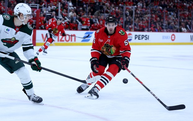 Chicago Blackhawks defenseman Artyom Levshunov (55) looks to take control of the puck in the first period of a game against the Minnesota Wild at the United Center in Chicago on Nov. 26, 2025. (Chris Sweda/Chicago Tribune)
