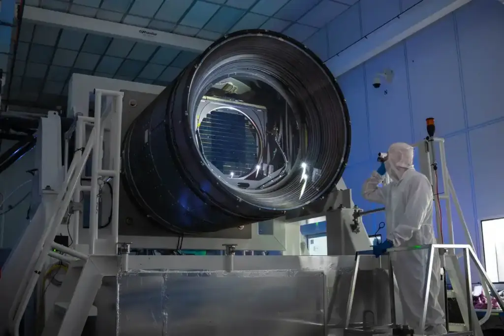 The large camera of the Vera C. Rubin Observatory pictured beside a worker.
