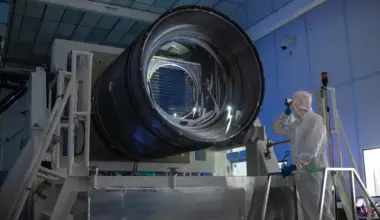 The large camera of the Vera C. Rubin Observatory pictured beside a worker.