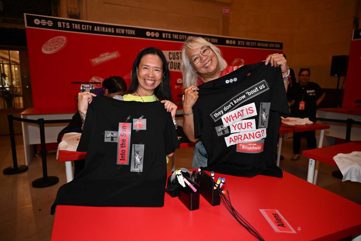 Fans show off their custom BTS shirts.