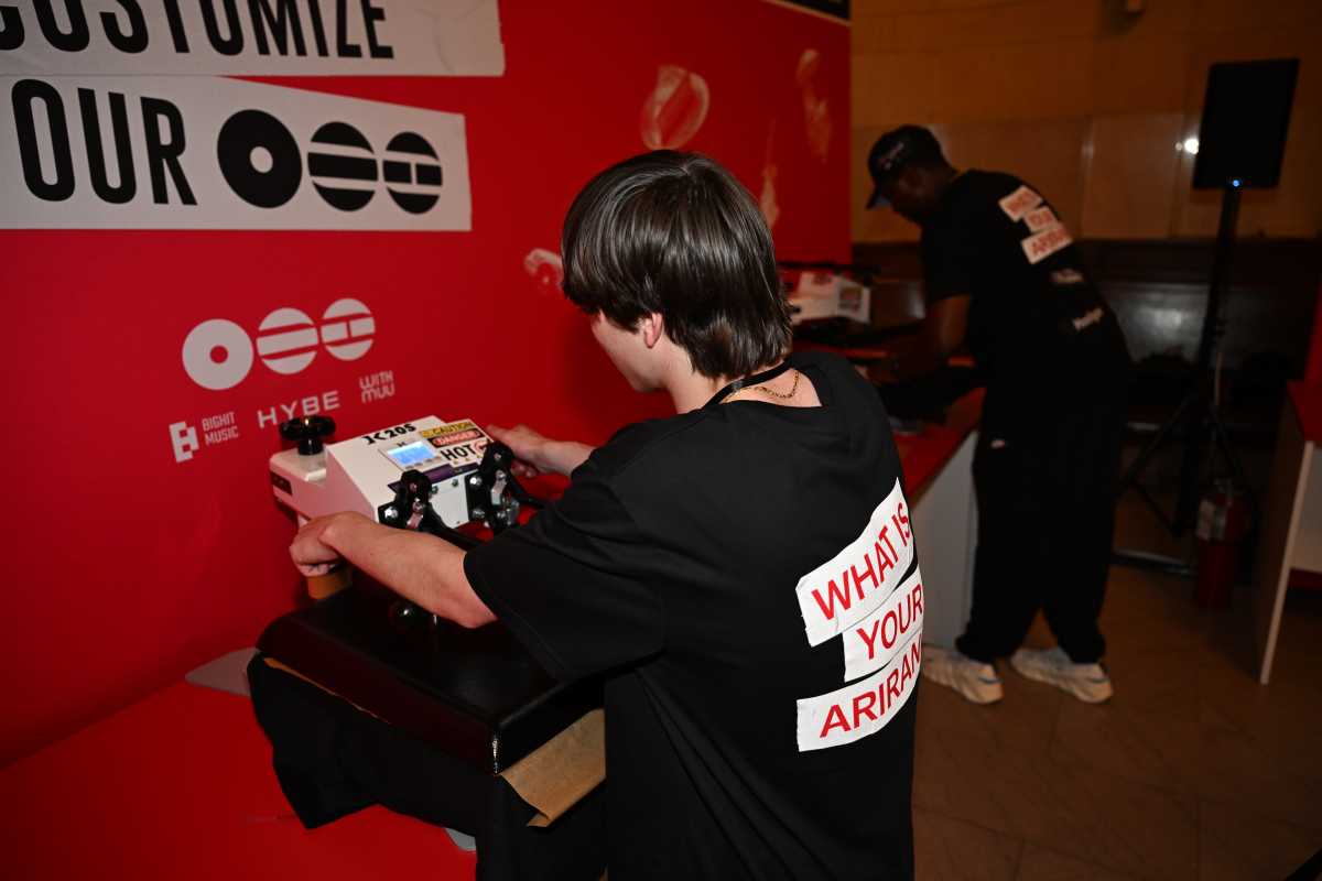 A staff member presses a t-shirt at the ARMY ‘MADANG’ pop-up at Grand Central Terminal.