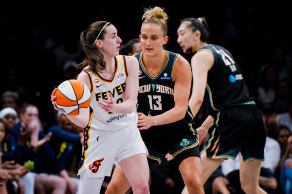Indiana Fever guard Caitlin Clark, left, guarded by New York Liberty forward Leonie Fiebich (13), looks to pass the ball during the first half of a WNBA basketball game, Saturday, Aug. 22, 2026, in New York. (AP Photo/Angelina Katsanis)