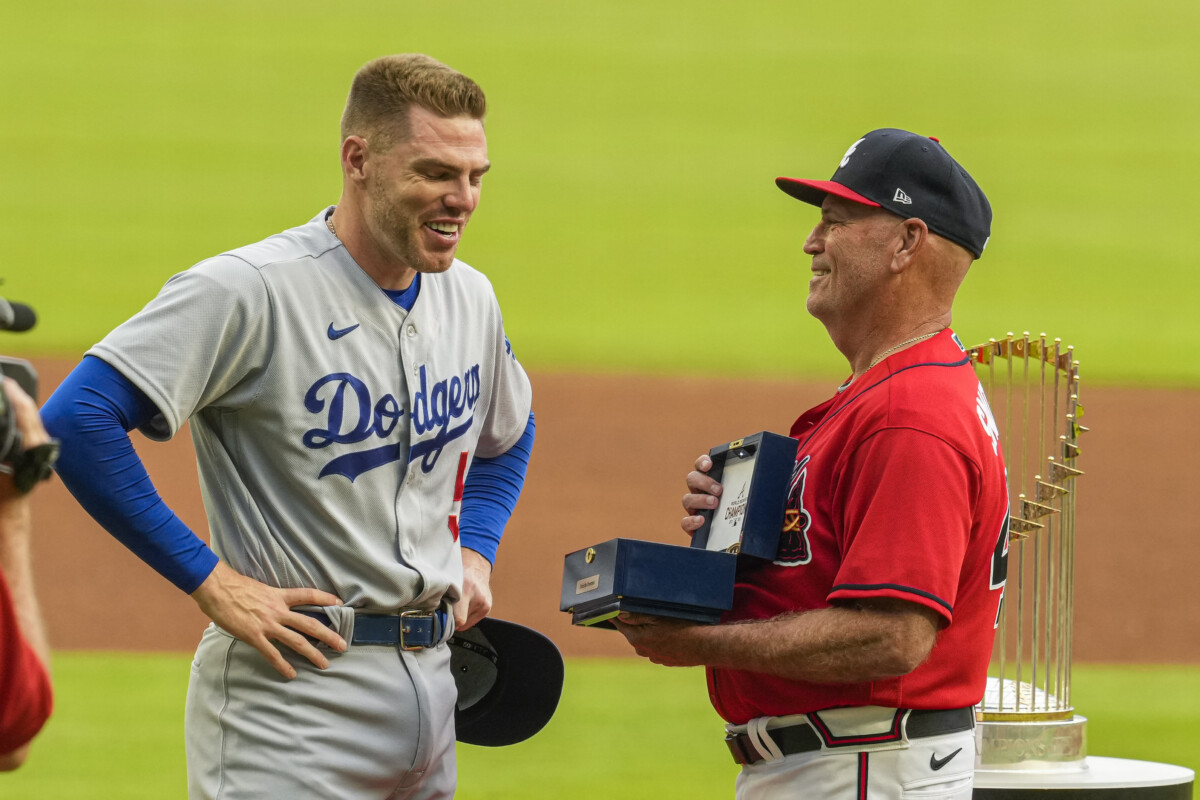 Jun 24, 2022; Cumberland, Georgia, USA; Los Angeles Dodgers first baseman Freddie Freeman (5) reacts as he receives his World Series ring from Atlanta Braves manager Brian Snitker (43) prior to the game at Truist Park. Mandatory Credit: Dale Zanine-USA TODAY Sports