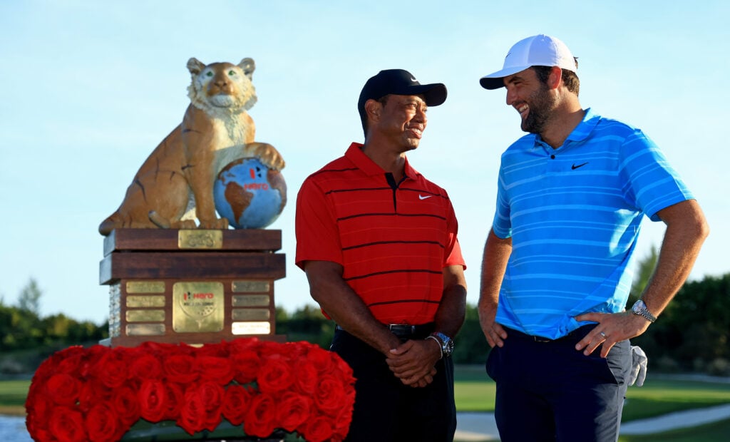 Scottie Scheffler of the United States and tournament host Tiger Woods pose with the trophy after winning the final round of the Hero World Challenge at Albany Golf Course