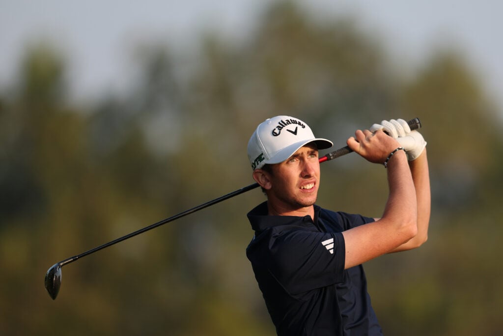 Tom McKibbin of Northern Ireland plays his second shot on the 18th hole on day two of the Hero Dubai Desert Classic