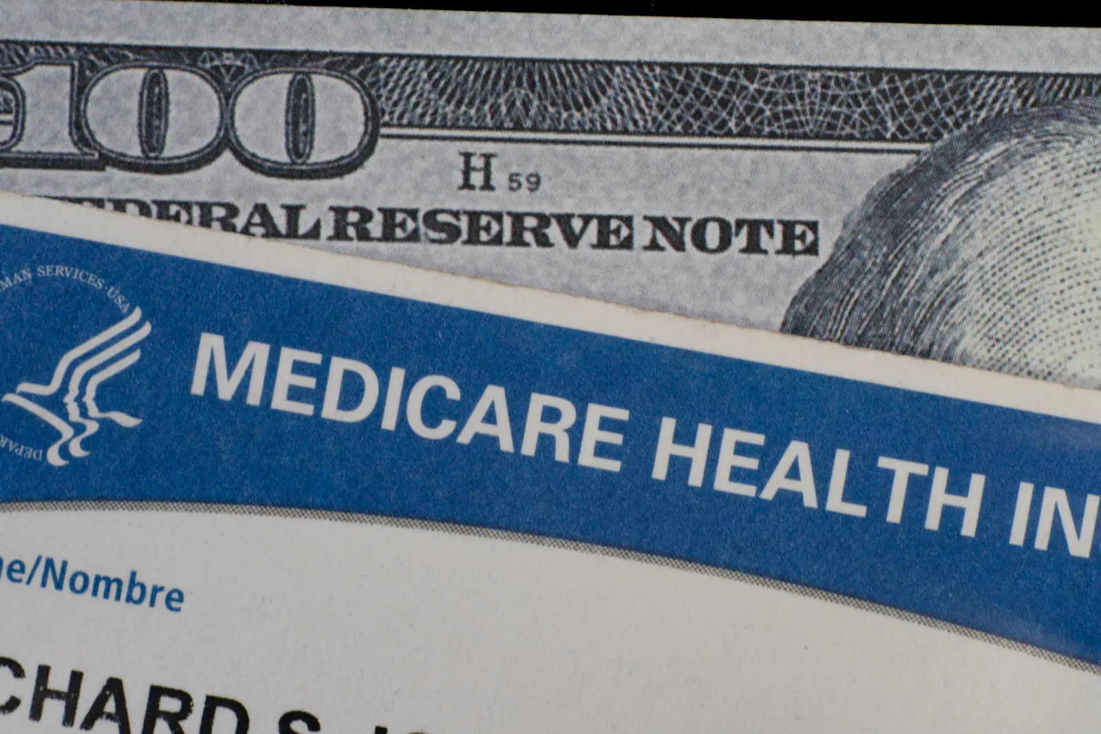Stock image/file photo: Close up of Medicare card and $100 bill.