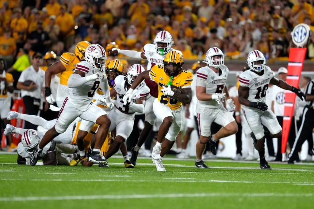 Missouri's Jamal Roberts runs away from five UMass defenders