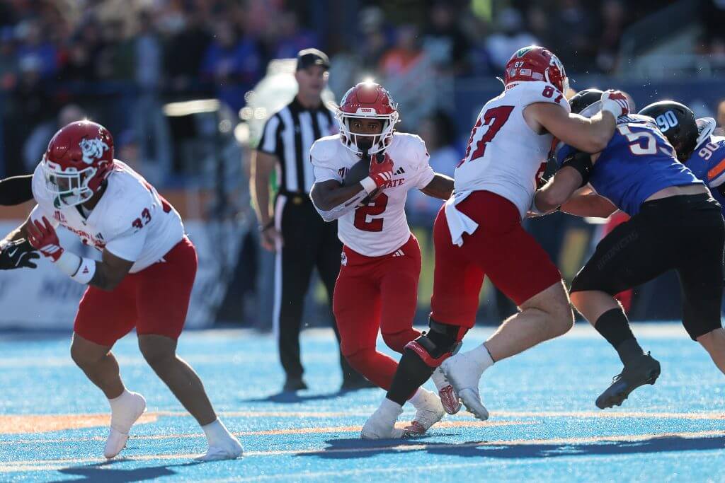 Rayshon Luke runs with the football while two Fresno State teammates block for him