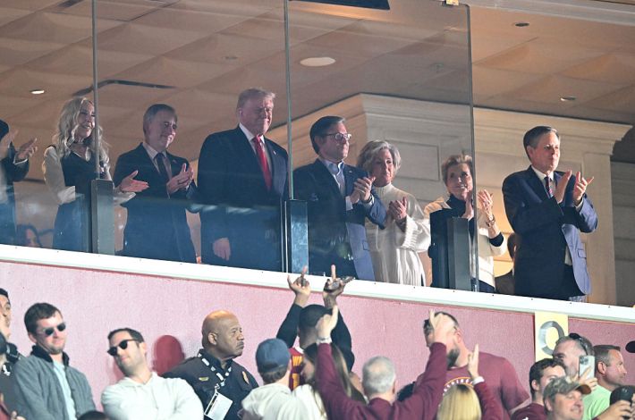 Marjorie Harris, wife of Washington Commanders owners Josh Harris, Harris U.S. President Donald Trump and U.S. Speaker of the House Rep. Mike Johnson (R-LA) look on during a game between the Detroit Lions and the Washington Commanders at Northwest Stadium on November 09, 2025 in Landover, Maryland.
