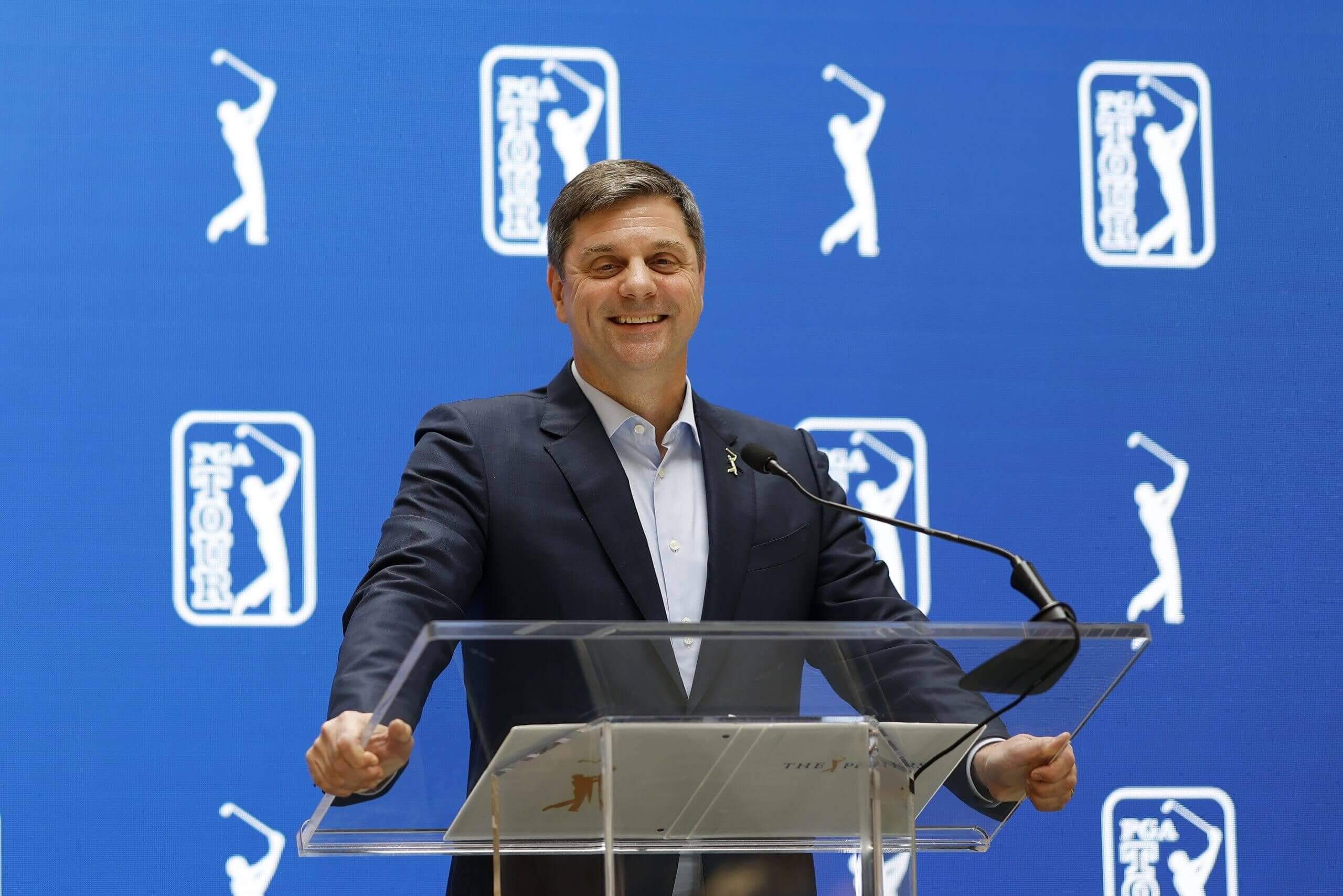 PGA Tour CEO Brian Rolapp speaks behind a lectern at The Players Championship.