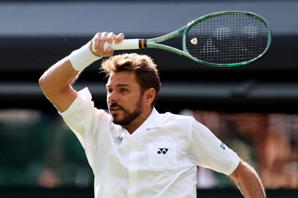 Stan Wawrinka hits a forehand with his racket finishing over his left shoulder.