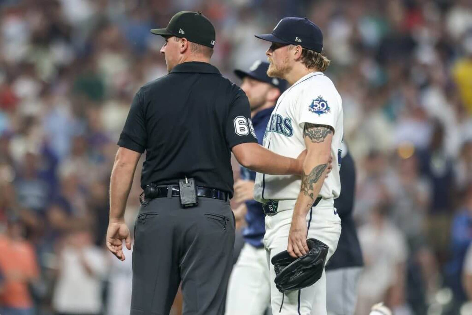 Gabe Speier of the Seattle Mariners is held back after hitting a batter during the eighth inning against the Detroit Tigers.