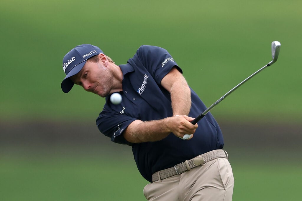 Russell Henley of the United States plays a shot on the first hole during the first round of the TOUR Championship 2026 at East Lake Golf Club