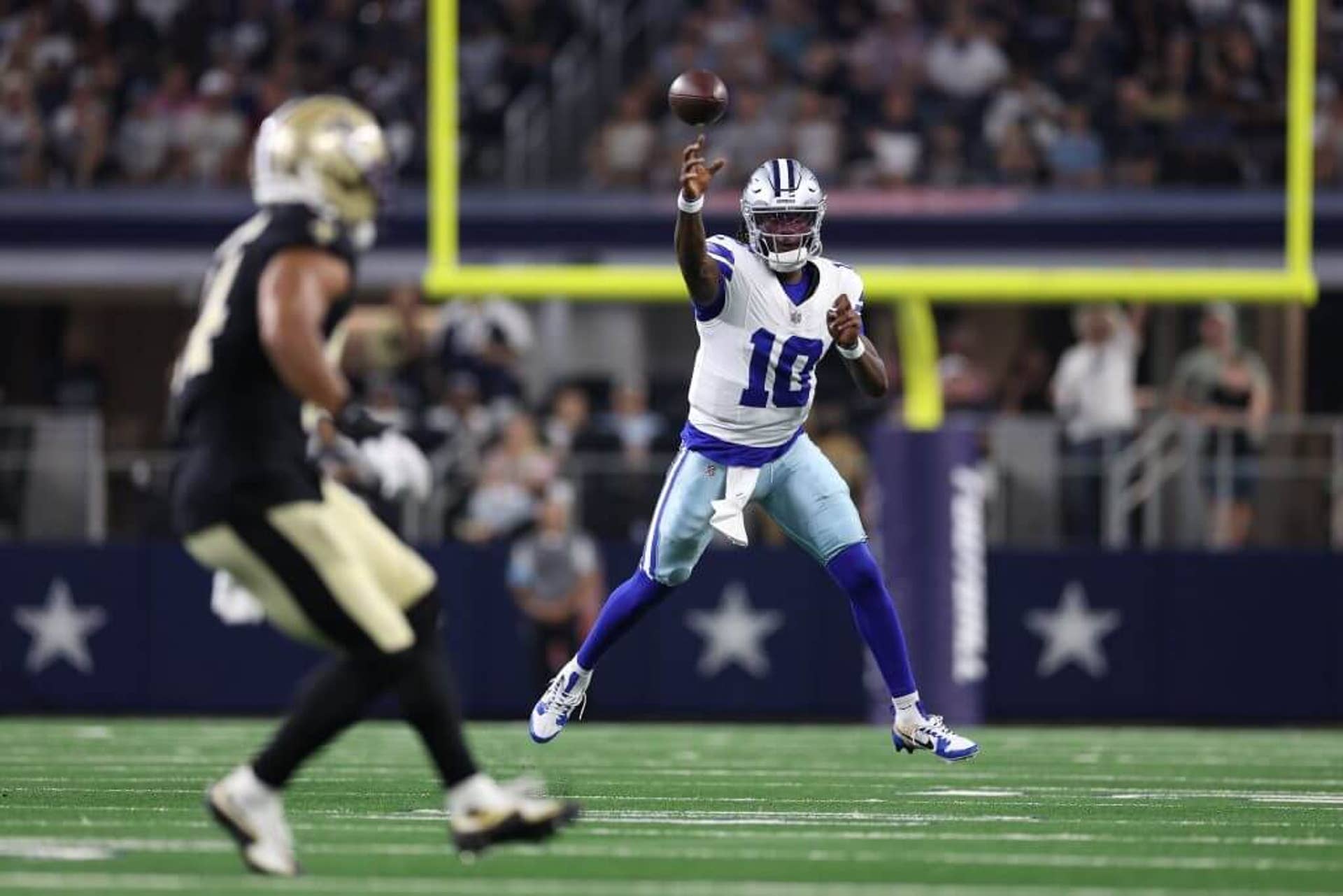 Joe Milton III of the Dallas Cowboys throws a pass on the run during a preseason game against the New Orleans Saints.