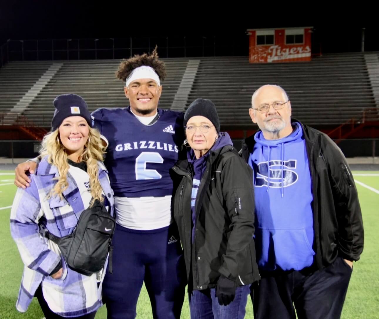 Sadiq, in high school, with mom Heather (left) and grandparents.
