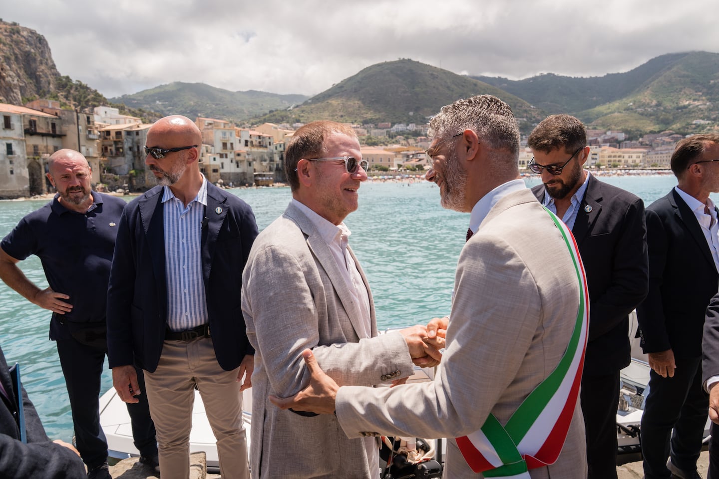 Tilman Fertitta, center left, the American ambassador to Italy, is welcomed by Mayor Daniele Tumminello, to Cefal, Sicily on July 4, 2026. Fertitta.
