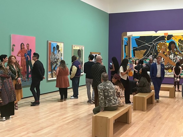 Guests browse the Museum of Contemporary Art San Diego exhibit "Giants: Art from the Dean Collection of Swizz Beatz and Alicia Keys" on April 17 in La Jolla. (Noah Lyons)