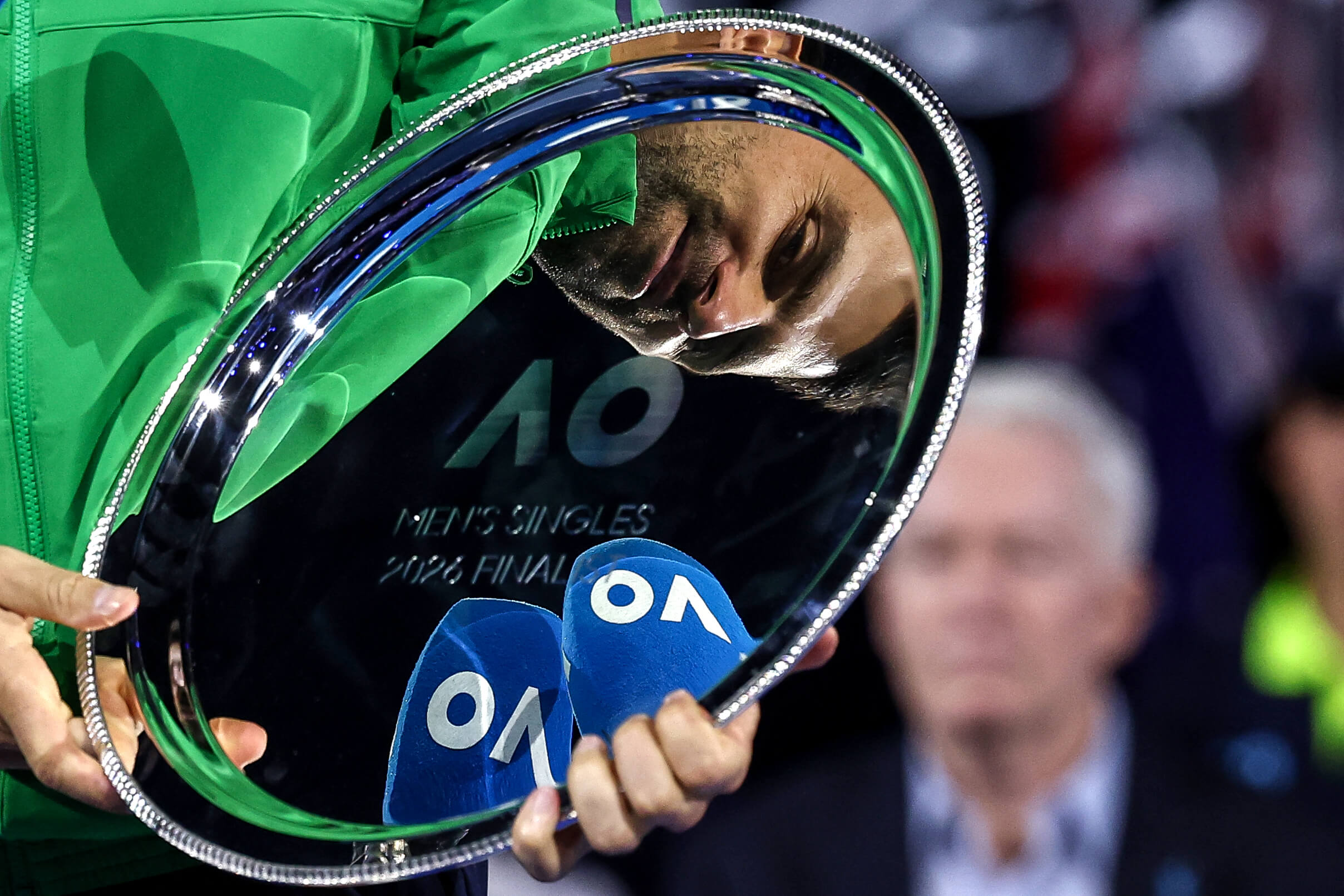 Novak Djokovic is reflected in the Australian Open runner's-up trophy.